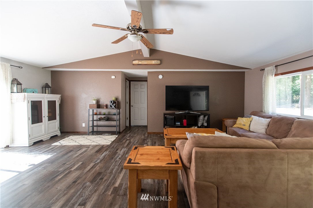 282 Woodard Road, Unit 79 Napavine, WA 98532 - Photo 14 of 29 a living room with furniture and a flat screen tv
