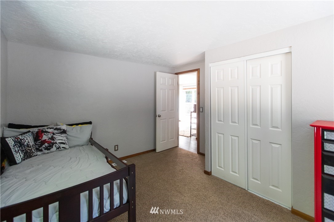 282 Woodard Road, Unit 79 Napavine, WA 98532 - Photo 19 of 29 a bedroom with a bed and wooden floor