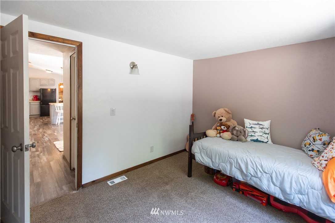 282 Woodard Road, Unit 79 Napavine, WA 98532 - Photo 20 of 29 a bedroom with a bed and a mirror