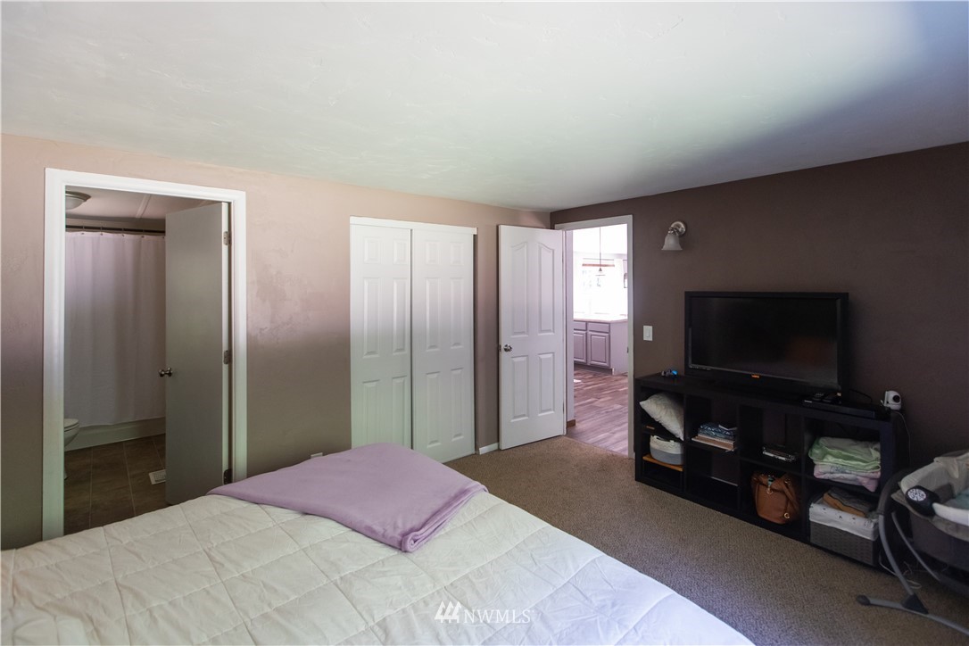 282 Woodard Road, Unit 79 Napavine, WA 98532 - Photo 24 of 29 a bedroom with a bed and a flat screen tv