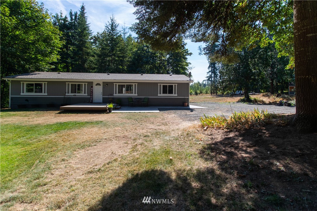 282 Woodard Road, Unit 79 Napavine, WA 98532 - Photo 9 of 29 a backyard of a house with yard and outdoor seating