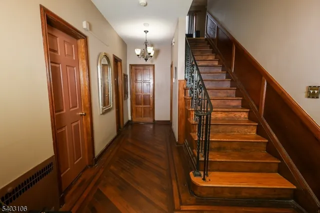 a view of entryway with wooden floor and stairs