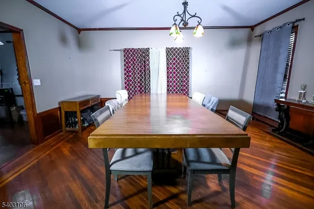 a view of a dining room with furniture wooden floor and chandelier