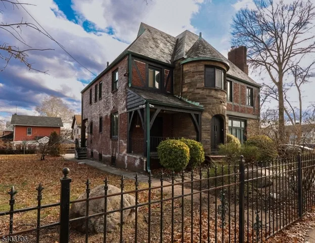 a view of a brick house with many windows