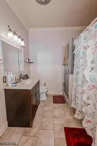a bathroom with a sink a toilet and shower curtain
