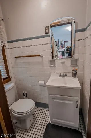 a bathroom with a sink toilet and mirror