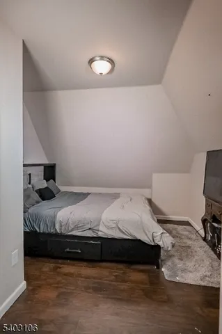 a bedroom with a bed and a chair