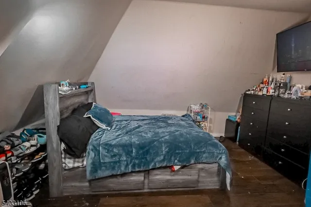 a bedroom with a bed and a television