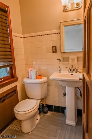 a bathroom with a sink mirror vanity and toilet