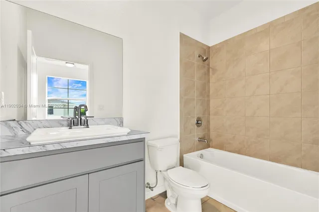a view of a house with a yard and potted plants