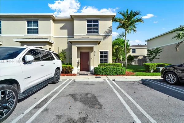a view of a car park in front of house