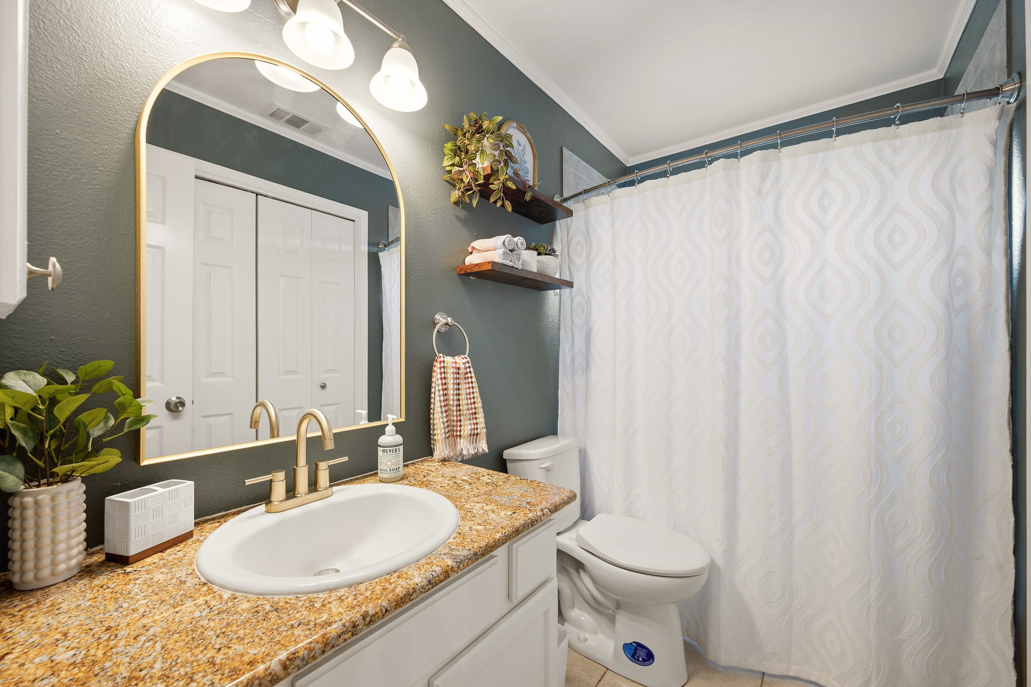 705 Canyon Bend Road Pflugerville, TX 78660 - Photo 18 of 23 a bathroom with a granite countertop sink toilet and mirror