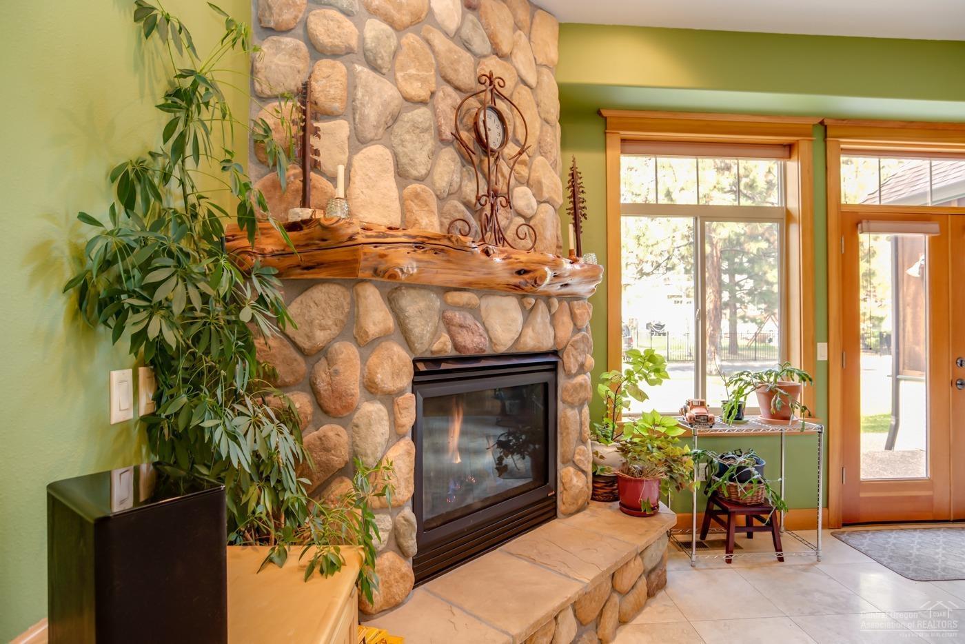 2429 Northwest Skyline Ranch Road Bend, OR 97703 - Photo 11 of 25 River rock fireplace with solid Juniper