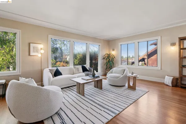 a living room with furniture a fireplace and a window