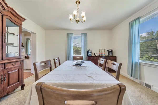 a kitchen with white cabinets and sink