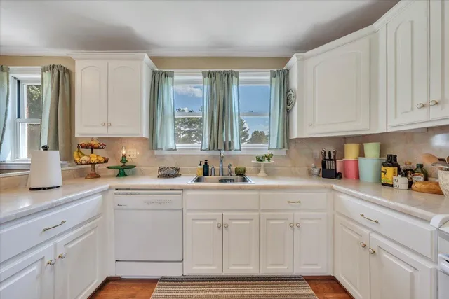 a kitchen with a sink a stove and cabinets