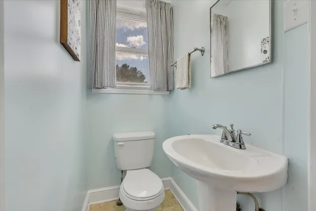 a bedroom with furniture and a large window