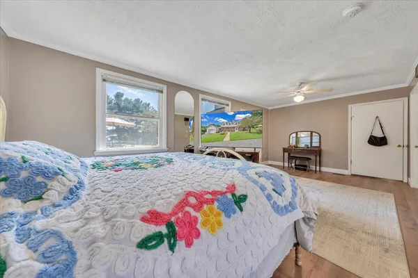 a bathroom with a granite countertop sink a toilet and a mirror