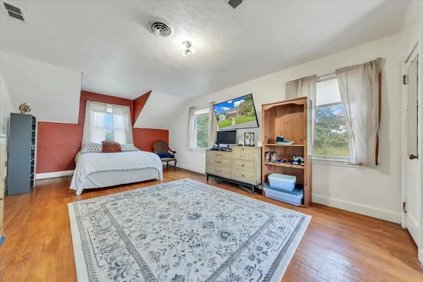 a bedroom with furniture and a dresser