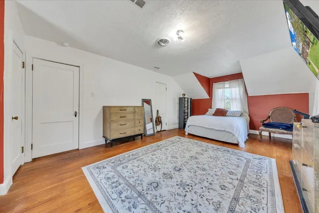 a view of front door with furniture and wooden floor