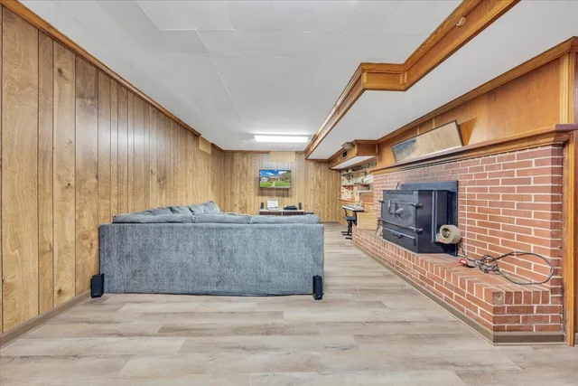 a view of a hallway with wooden floor and furniture