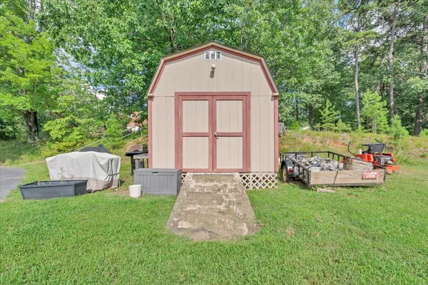 a front view of a house with a garden and yard