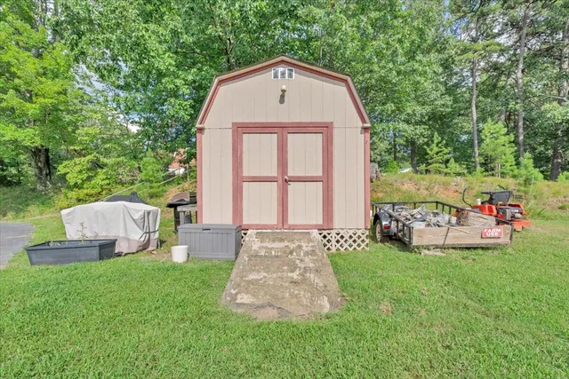 a front view of a house with a garden and yard