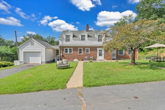 a front view of a house with garden and porch