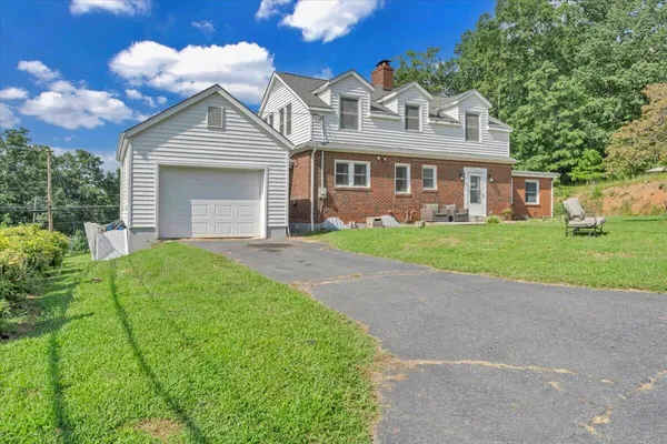 a front view of a house with a garden and plants