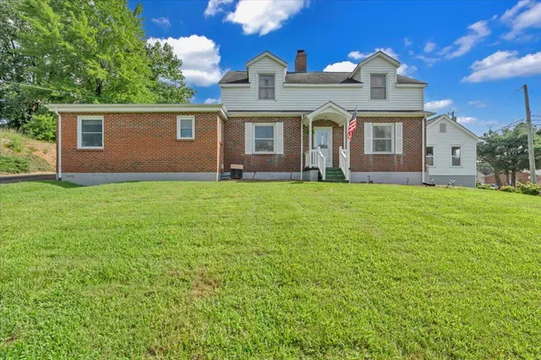an aerial view of a house with garden space and street view