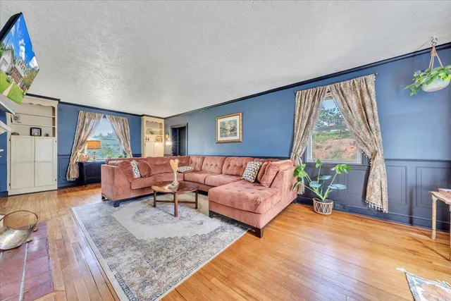 a view of a dining room with furniture and chandelier