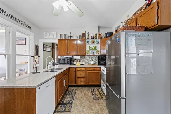 a living room with furniture a rug and a window