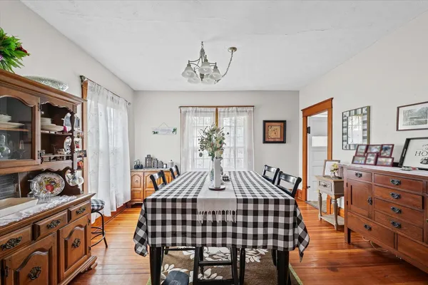 a room that has a lot of wall paintings on the wall and a dresser