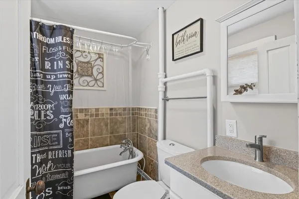 a bedroom with a bed and ceiling fan