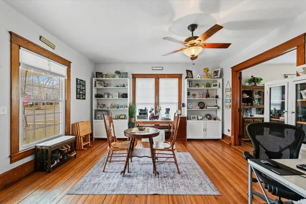 a living room with furniture a rug and a large window