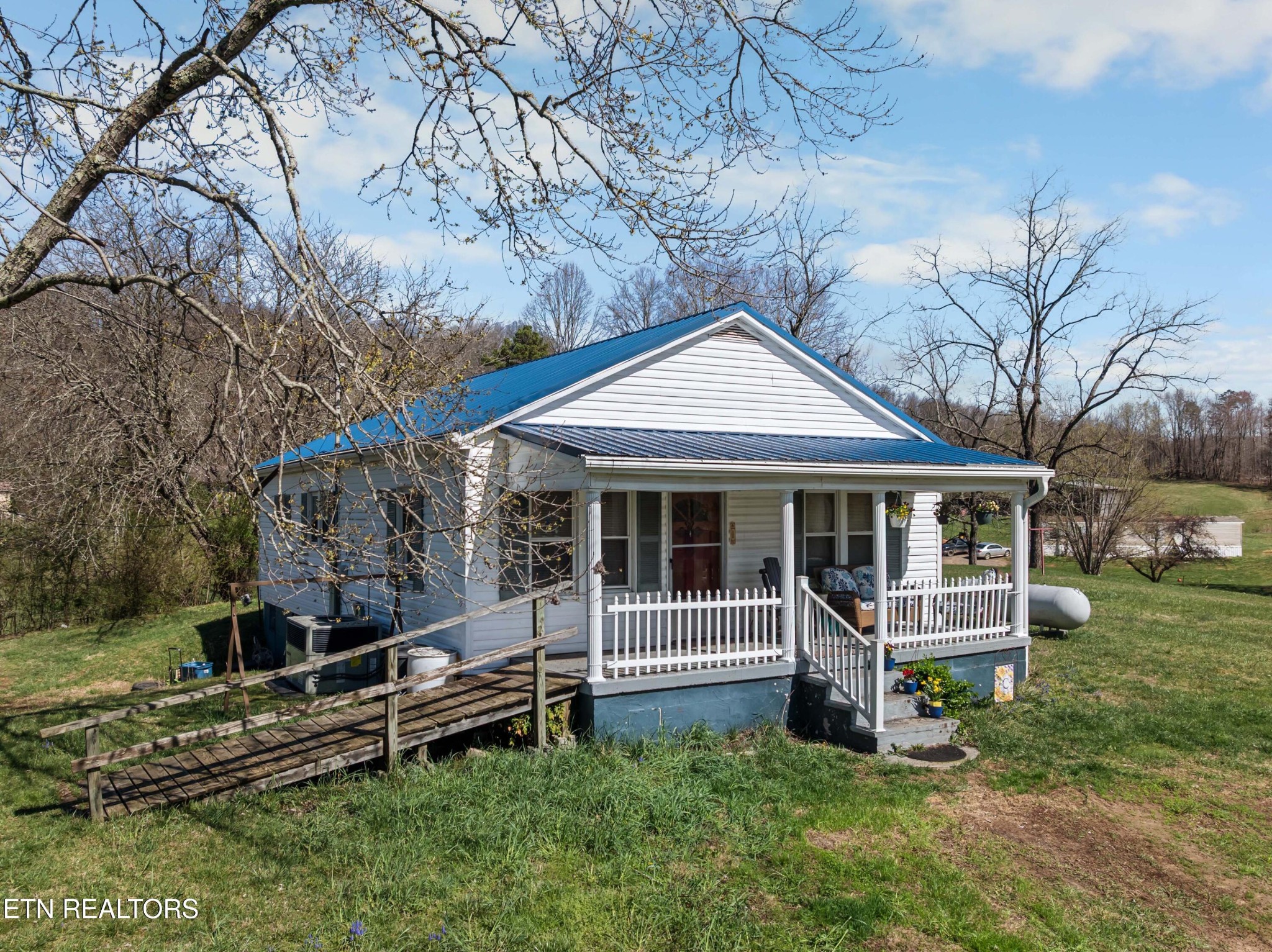 385 Hubbs Grove Road Maynardville, TN 37807 - Photo 21 of 33 a front view of a house with a yard table and chairs