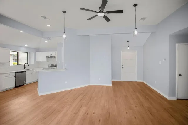 a view of a kitchen with a microwave and a stove