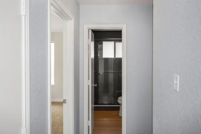 a view of a bathroom from a corridor