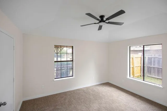 a view of room with window and ceiling fan