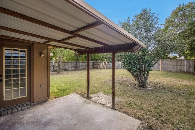 a view of a house with backyard and a porch