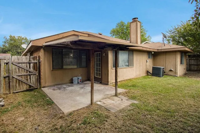 a view of a house with wooden fence