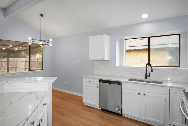 a kitchen with a sink cabinets and window