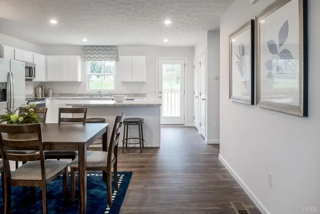 a view of a dining room with furniture and wooden floor
