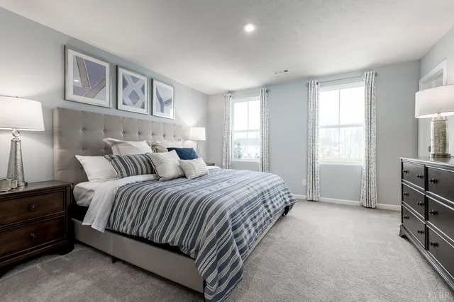 a spacious bedroom with a bed and a cabinets