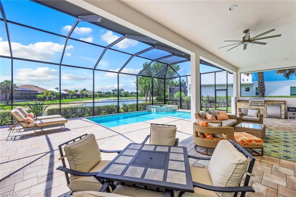 a living room with patio furniture and a floor to ceiling window