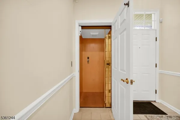 a view of staircase with railing and white walls