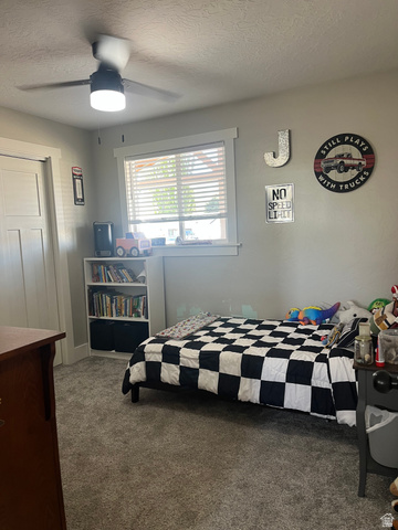 558 North N Cres Road Roosevelt, UT 84066 - Photo 15 of 31 Carpeted room featuring a ceiling fan with integrated lighting, a window with horizontal blinds, and a built-in bookshelf