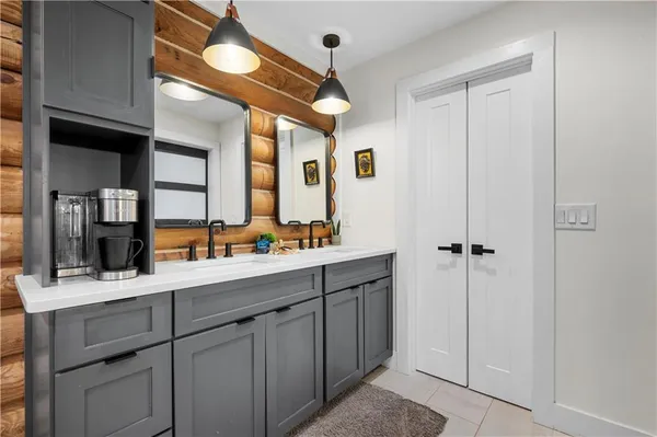 a bathroom with a double vanity sink and a mirror