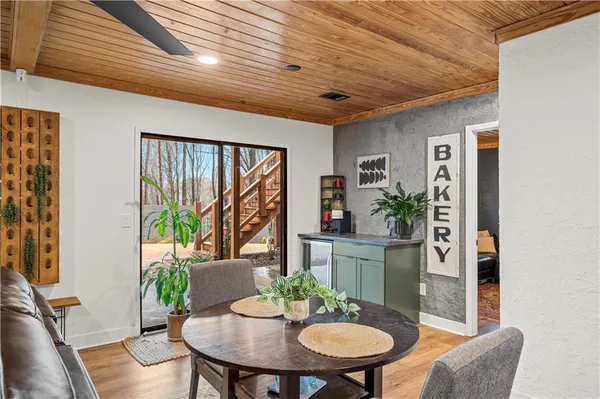 a view of a dining room with furniture window and wooden floor