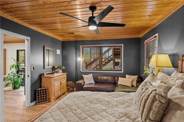 a bedroom with furniture and a large window